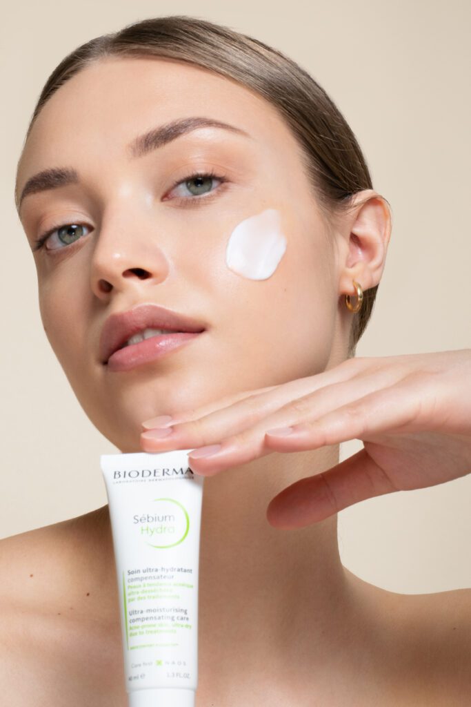 High quality beauty photography with female model having face cream texture on the face. 